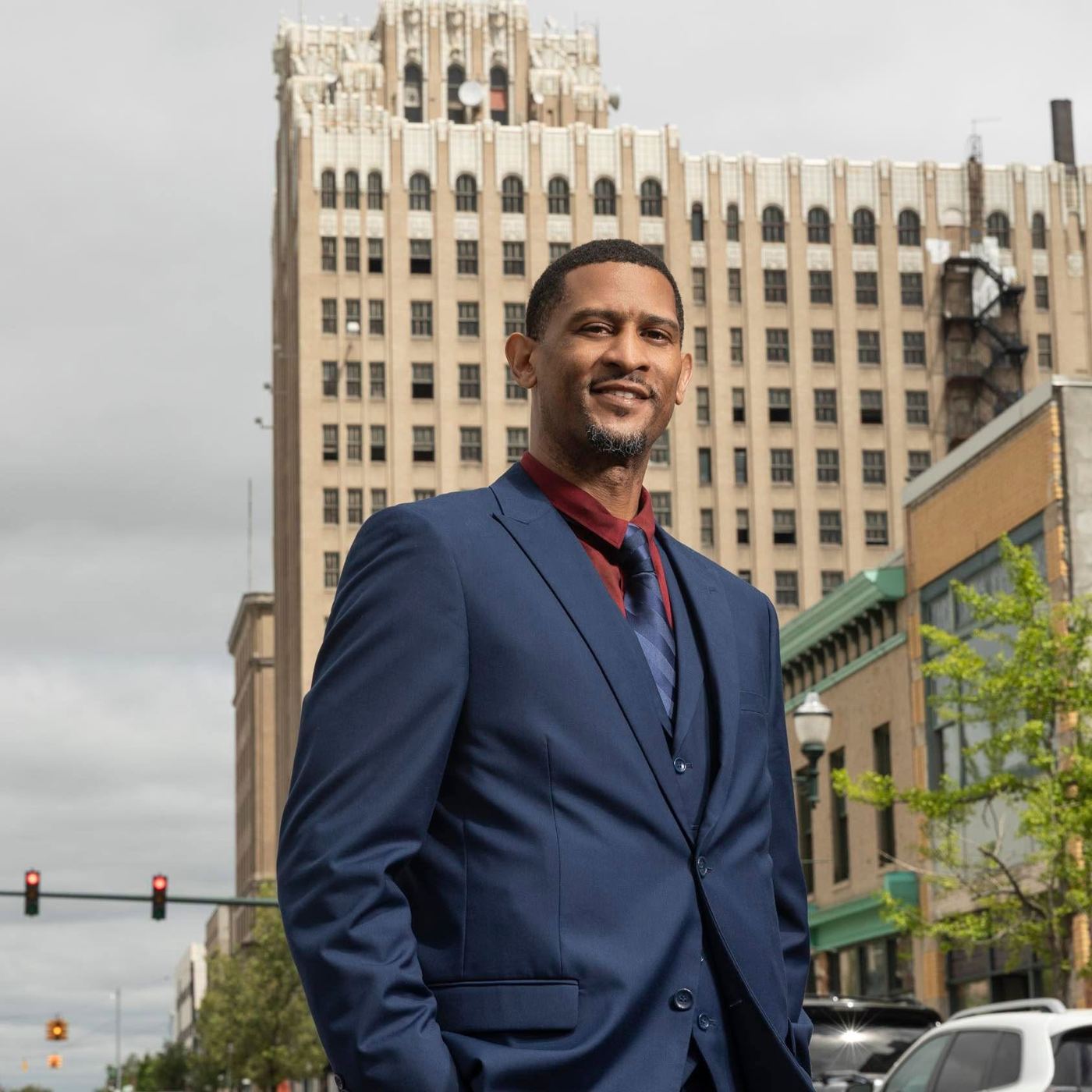 Marcus Bowman in a navy suit on a street in downtown Pontiac